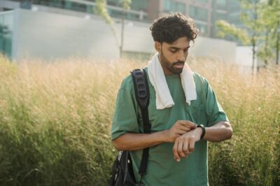 man setting smartwatch before exercise